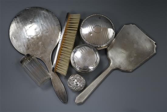 Two silver backed hand mirrors, brush, silver trinket box, a silver pill box and two dressing table jars.